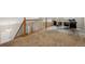 Loft area with wood railing, plush carpet, and a home office setup at 6519 Eastview St, Longmont, CO 80504