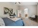 Bright main bedroom features a ceiling fan, art and a private bathroom, creating a serene retreat at 6519 Eastview St, Longmont, CO 80504