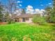 A spacious backyard featuring a lush lawn, mature trees, and a cozy patio area at 8546 E Mineral Cir, Centennial, CO 80112