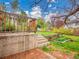 Backyard boasts a wooden deck with steps leading to a lush garden and expansive grassy area at 8546 E Mineral Cir, Centennial, CO 80112