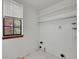 Unfinished basement with white walls, a window, and potential for customization at 8546 E Mineral Cir, Centennial, CO 80112