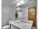 Bathroom featuring a marble vanity, modern fixtures, and a glass-enclosed shower at 8546 E Mineral Cir, Centennial, CO 80112