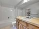 Bright bathroom with a tub and shower combo, and a sink with a vanity at 8546 E Mineral Cir, Centennial, CO 80112
