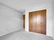 Comfortable bedroom with soft carpet and a spacious closet with wooden doors at 8546 E Mineral Cir, Centennial, CO 80112