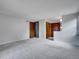This bedroom features neutral colored walls and carpet and multiple doorways at 8546 E Mineral Cir, Centennial, CO 80112