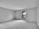 Bright bedroom featuring neutral paint, plush carpet, and a large window offering natural light at 8546 E Mineral Cir, Centennial, CO 80112
