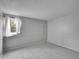 This bedroom features a window with sheer white curtains and neutral carpeting at 8546 E Mineral Cir, Centennial, CO 80112