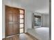Inviting entrance featuring a custom front door and hardwood floors, with a view into the living room at 8546 E Mineral Cir, Centennial, CO 80112