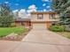 Charming two-story home featuring a two car garage, brick accents, and a well kept lawn at 8546 E Mineral Cir, Centennial, CO 80112