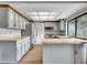 Well-lit kitchen features blue cabinets, stainless steel appliances, and light countertops with a view to the backyard at 8546 E Mineral Cir, Centennial, CO 80112