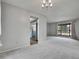 Dining area with chandelier and large window, conveniently connected to a charming kitchen at 8546 E Mineral Cir, Centennial, CO 80112