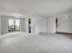 Inviting living room with large window and stylish chandelier, seamlessly flowing into adjacent rooms at 8546 E Mineral Cir, Centennial, CO 80112