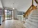 Bright living room features a sliding door to back yard, staircase to upper level, and modern light fixture at 8546 E Mineral Cir, Centennial, CO 80112