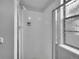 Clean, bright shower stall with white tile and a glass door at 8546 E Mineral Cir, Centennial, CO 80112