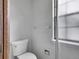 Toilet with a towel rack, window and shower in a tiled bathroom at 8546 E Mineral Cir, Centennial, CO 80112