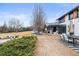 Spacious backyard with covered patio, covered pool, dining area, and mature trees, ideal for entertaining and relaxation at 7829 Nile Cir, Arvada, CO 80007