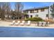 Expansive backyard featuring a pool with cover, lounge chairs, manicured landscaping, and a well-maintained home exterior at 7829 Nile Cir, Arvada, CO 80007