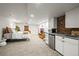 Finished basement features a small kitchen area with a bedroom in the background at 7829 Nile Cir, Arvada, CO 80007