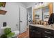 Powder bathroom showcasing a granite vanity, modern fixtures, and hardwood floors at 7829 Nile Cir, Arvada, CO 80007