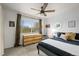 Bright bedroom featuring a neutral color scheme, ceiling fan, and window views at 7829 Nile Cir, Arvada, CO 80007