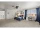 Well-lit bedroom with a ceiling fan, large windows and a dedicated study corner with natural light at 7829 Nile Cir, Arvada, CO 80007