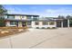 Charming two-story home featuring a welcoming porch and an expansive concrete driveway at 7829 Nile Cir, Arvada, CO 80007