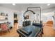 Bright flex room with hardwood floors, a massage table, and contemporary decor at 7829 Nile Cir, Arvada, CO 80007