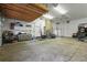 Spacious garage with exposed ceiling, brick column, and multiple storage areas at 7829 Nile Cir, Arvada, CO 80007