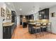 Modern kitchen featuring dark cabinets, hardwood floors and granite countertops at 7829 Nile Cir, Arvada, CO 80007