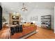 Cozy living room featuring a stone fireplace, hardwood floors, and vaulted ceilings at 7829 Nile Cir, Arvada, CO 80007