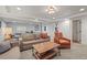 Finished basement with multiple seating areas, a ping pong table, and neutral carpeting at 7829 Nile Cir, Arvada, CO 80007