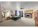 Spacious main bedroom featuring a fireplace, a ceiling fan, and large windows with natural light at 7829 Nile Cir, Arvada, CO 80007