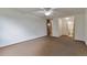 Spacious bedroom showcasing neutral carpet with access to an adjoining bathroom at 9340 E Center Ave # 8A, Denver, CO 80247