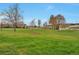 Expansive green space featuring lush lawns, mature trees, and surrounding apartment buildings under a clear blue sky at 9340 E Center Ave # 8A, Denver, CO 80247