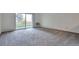 Bright living room with sliding glass doors to a patio, and neutral carpet at 9340 E Center Ave # 8A, Denver, CO 80247