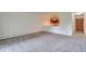 Spacious living room with neutral carpet, white walls and view to the kitchen at 9340 E Center Ave # 8A, Denver, CO 80247