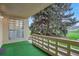 Charming outdoor patio with vibrant green turf, decorative block wall, and mature landscaping in a serene setting at 9340 E Center Ave # 8A, Denver, CO 80247