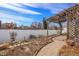 Inviting backyard with wooden pergola, white vinyl privacy fence, and brick-paved walkway at 20764 E 47Th Ave, Denver, CO 80249