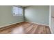 This bedroom features wood flooring and a window with blinds for natural light at 20764 E 47Th Ave, Denver, CO 80249