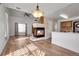 Open-concept living room with fireplace and adjacent kitchen creates an inviting atmosphere for entertaining at 20764 E 47Th Ave, Denver, CO 80249