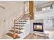 Open floor plan featuring a staircase, fireplace, and access to the second story at 20764 E 47Th Ave, Denver, CO 80249