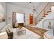 Inviting living room featuring a staircase, natural light, and stylish decor at 20764 E 47Th Ave, Denver, CO 80249