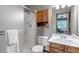 The updated bathroom includes a walk-in shower, oak cabinets, a marble sink, and modern fixtures at 3254 Red Tree Pl, Castle Rock, CO 80104