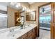 Bathroom featuring a double sink vanity with marble countertop and wooden cabinetry at 3254 Red Tree Pl, Castle Rock, CO 80104