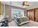 Bright bedroom showcasing a window with views, a ceiling fan, and closet at 3254 Red Tree Pl, Castle Rock, CO 80104