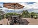 Outdoor deck featuring patio furniture, a large umbrella, and beautiful scenic views at 3254 Red Tree Pl, Castle Rock, CO 80104