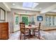 Bright dining area with a round wood table, a large window, and ample natural light at 3254 Red Tree Pl, Castle Rock, CO 80104