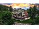 Stunning two-story home featuring a spacious deck, lush landscaping, and mountain views at sunset at 3254 Red Tree Pl, Castle Rock, CO 80104