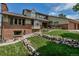 Charming home with a well-manicured lawn, stone retaining wall, and inviting entrance at 3254 Red Tree Pl, Castle Rock, CO 80104