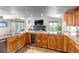 Bright kitchen with a wine fridge, granite countertops, sink, and a view to the living room at 3254 Red Tree Pl, Castle Rock, CO 80104